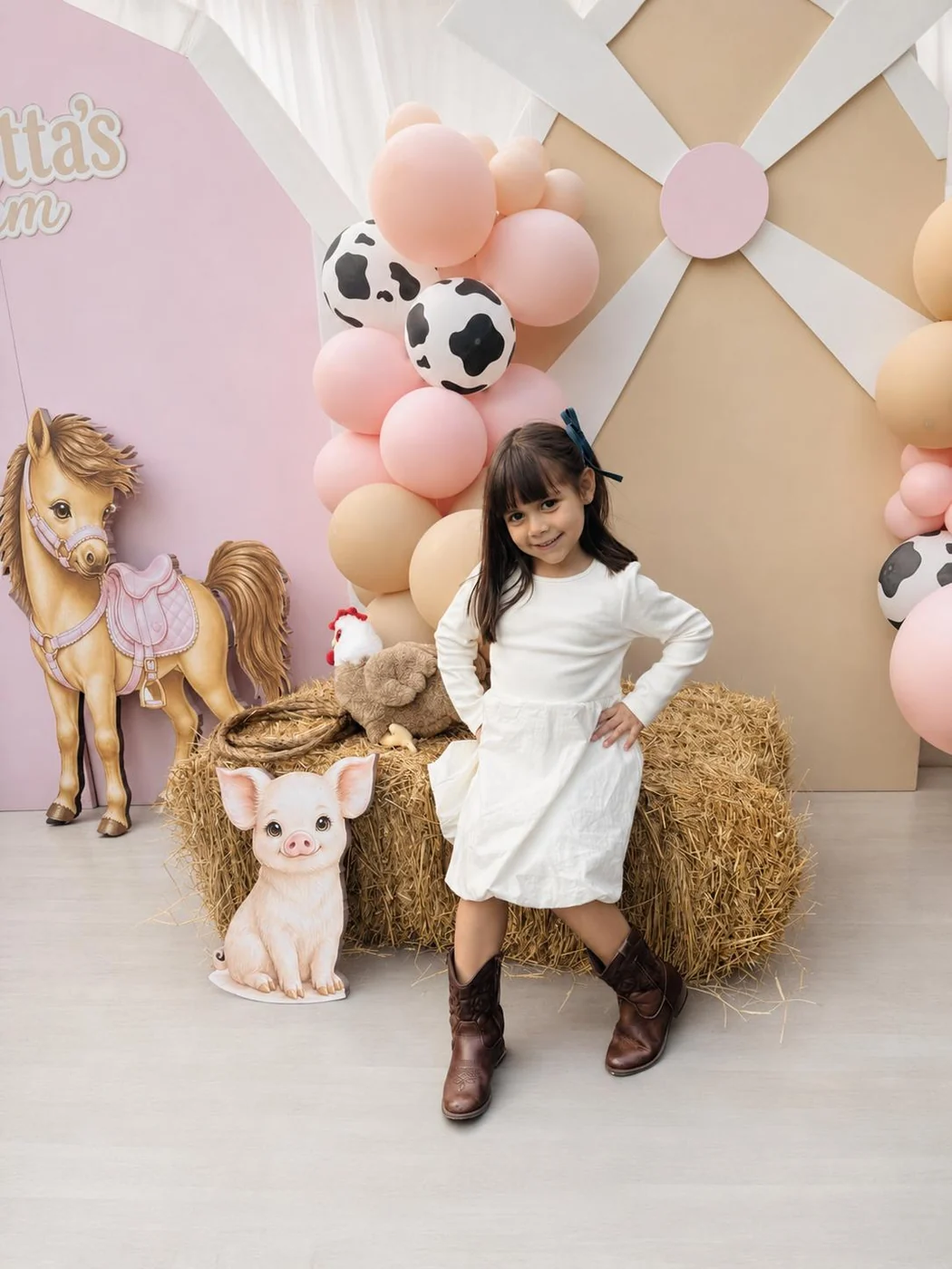 Young guest posing at a pastel farm-themed celebration