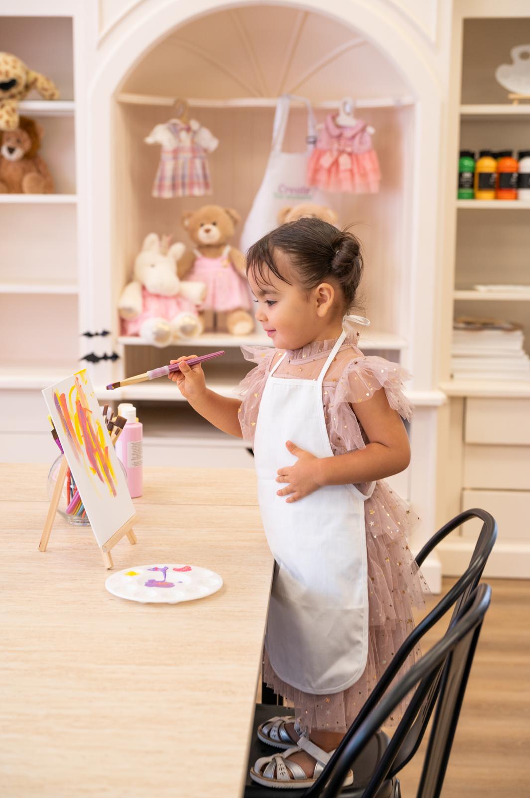 Young guest painting her own canvas at the studio