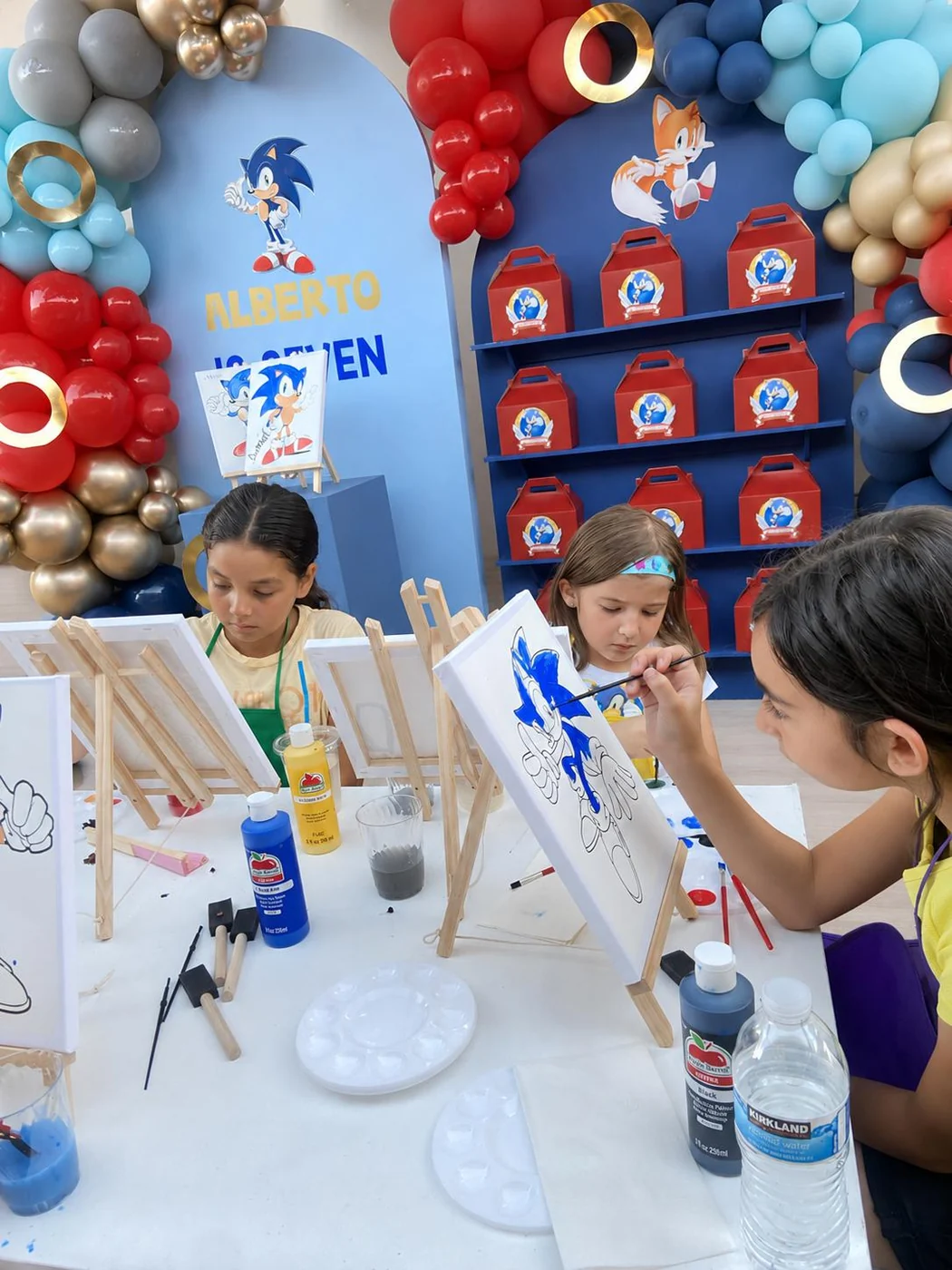 Children painting canvases at a Sonic-themed celebration